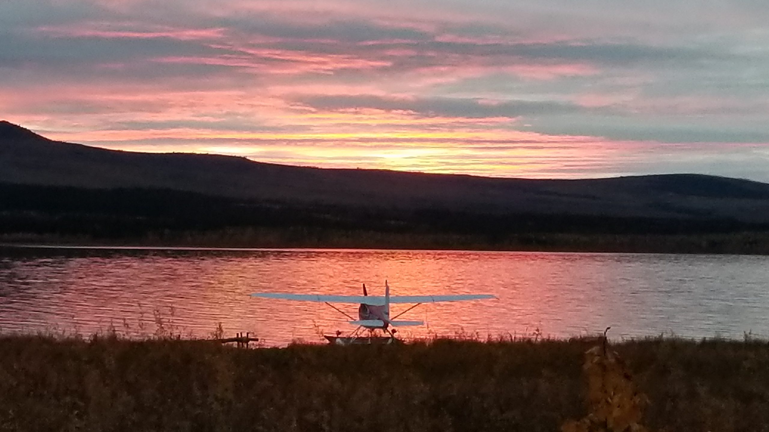a plane on the float pond with the sunset
